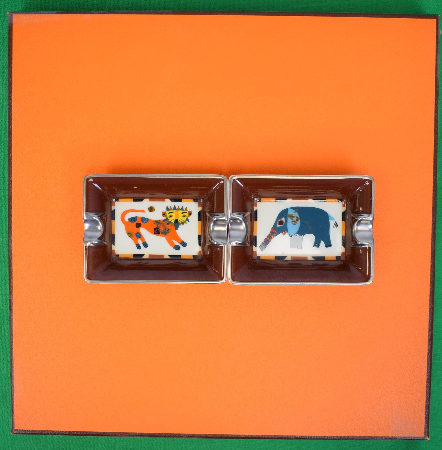"Set x 2 Hermès Paris Porcelain Change/ Mini Ashtrays w/ Elephant & Lion Motifs" Provenance: The Susie Hilfiger Collection