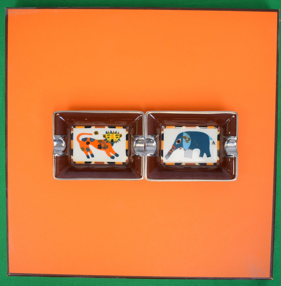 "Set x 2 Hermès Paris Porcelain Change/ Mini Ashtrays w/ Elephant & Lion Motifs" Provenance: The Susie Hilfiger Collection