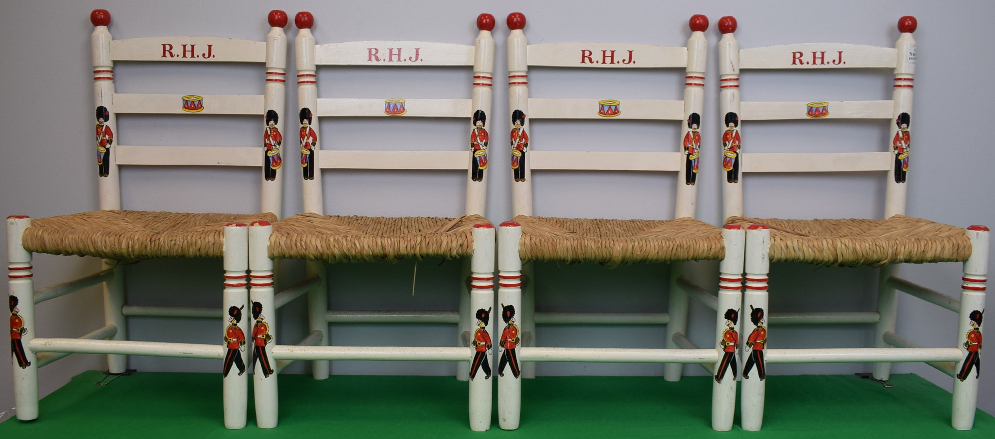 "Set x 4 Children's Wooden Chairs w/ Wicker Seats and Hand Painted King's Guards" Provenance: The Susie Hilfiger Collection