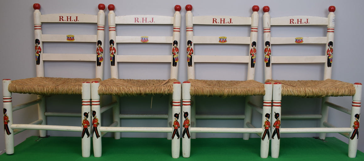 "Set x 4 Children's Wooden Chairs w/ Wicker Seats and Hand Painted King's Guards" Provenance: The Susie Hilfiger Collection