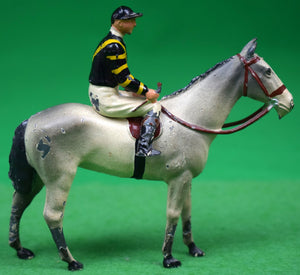 "Britains Jockey w/ Navy/ Yellow Silks on Gray Racehorse"